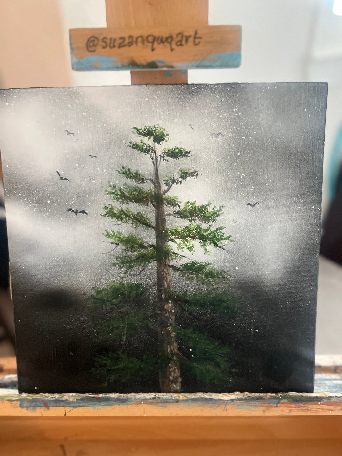 Artistic depiction of a tree with a foggy background on a canvas, signed 'suzanquart'.