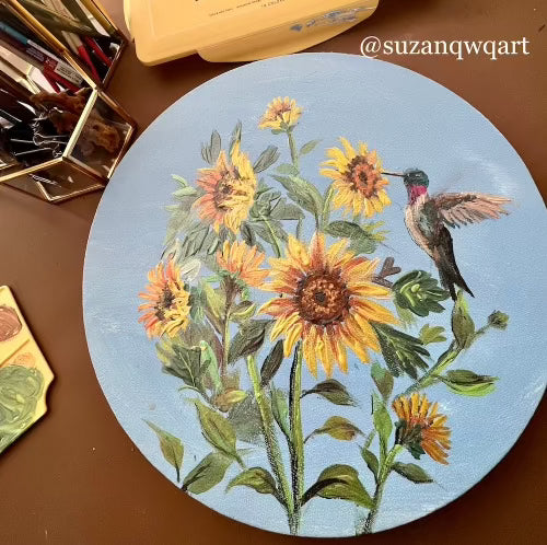 Sunflowers and a hummingbird painting on a round canvas